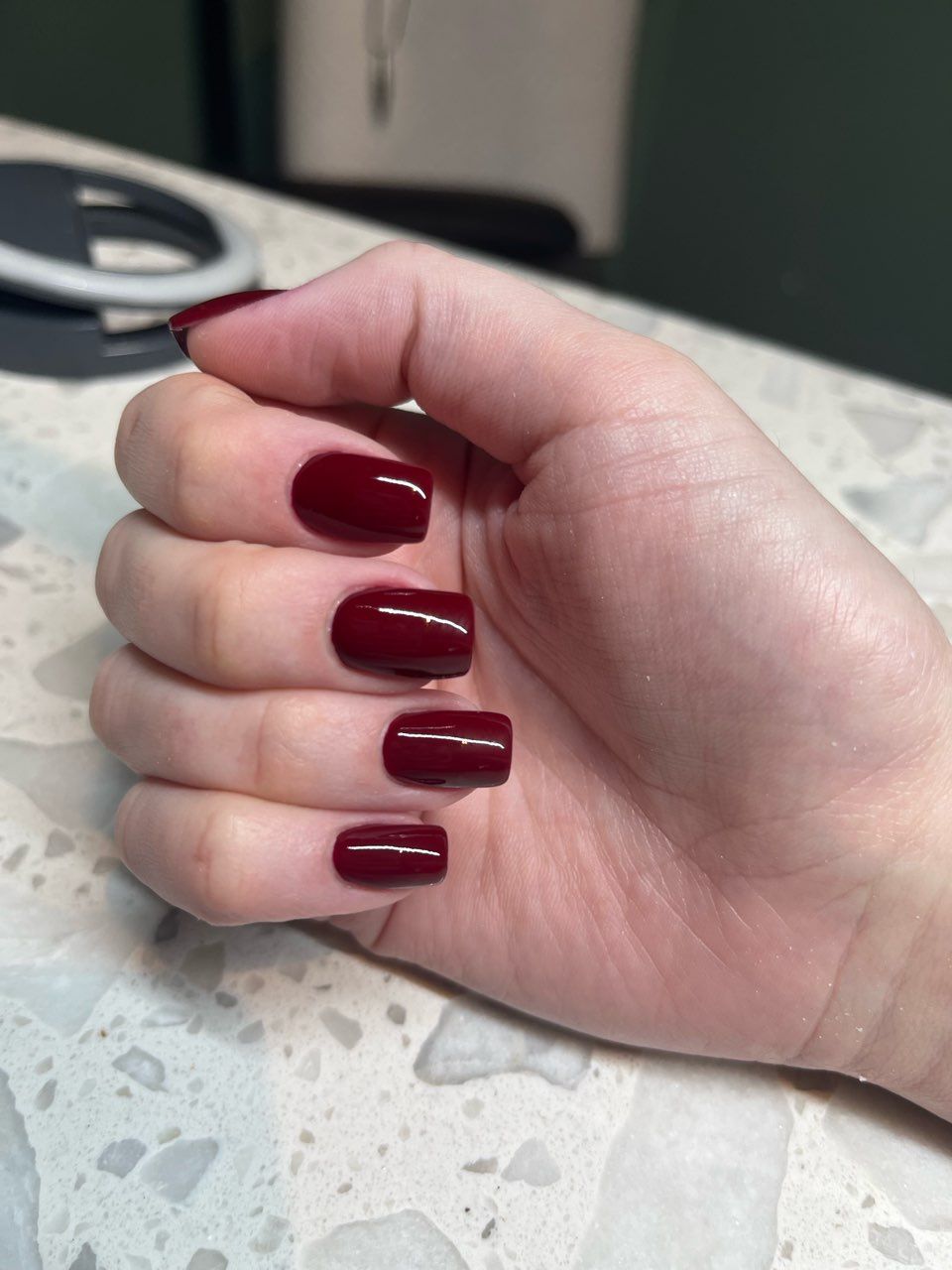 A close up of a woman 's nails with a french manicure.
