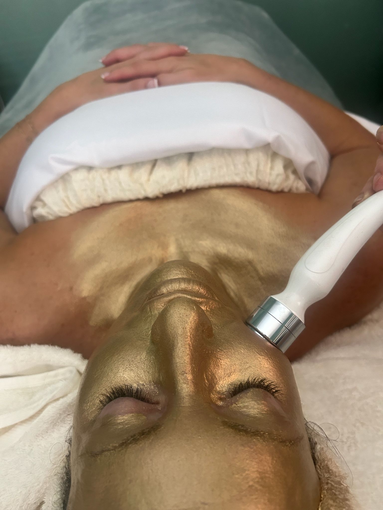 Client experiencing a luxury 24K gold facial with oxygen therapy at Spa La La Tampa, targeting fine lines, elasticity, and radiant skin.