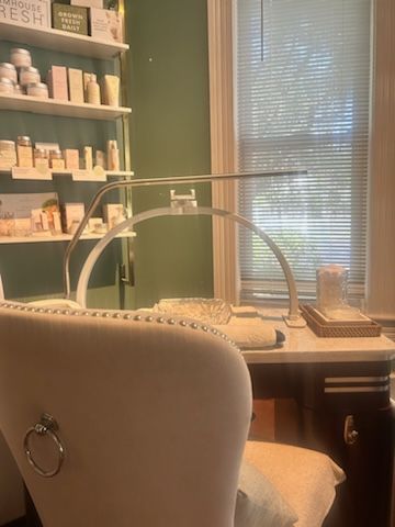 Interior view of Spa La La Tampa’s nail salon area featuring  FarmHouse Fresh skincare products displayed on shelves.