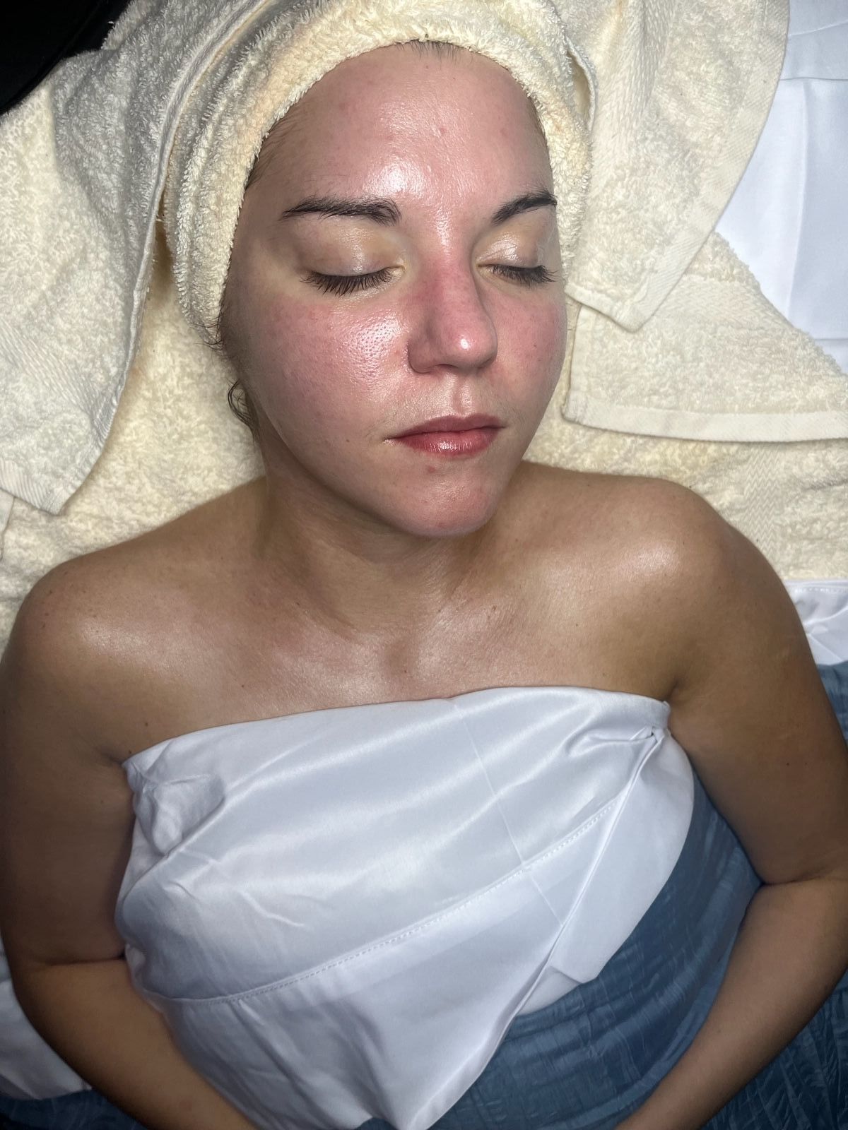A woman is getting a facial treatment at a spa.