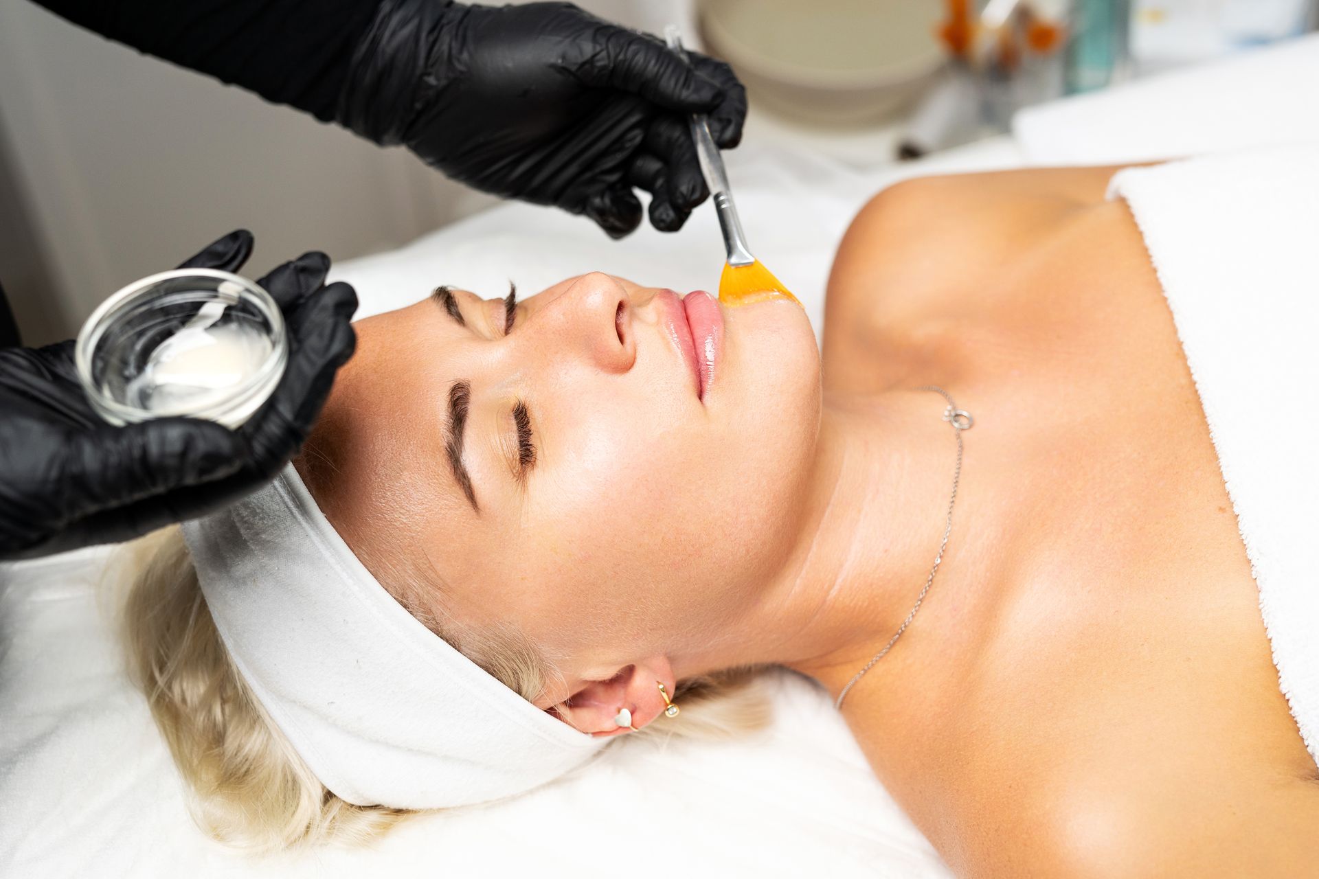 A woman is getting a facial treatment at a spa.