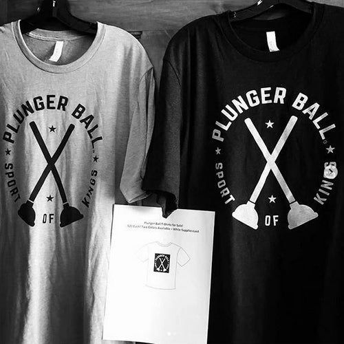 A gray t-shirt and a black t-shirt hanging side by side, both printed with a 