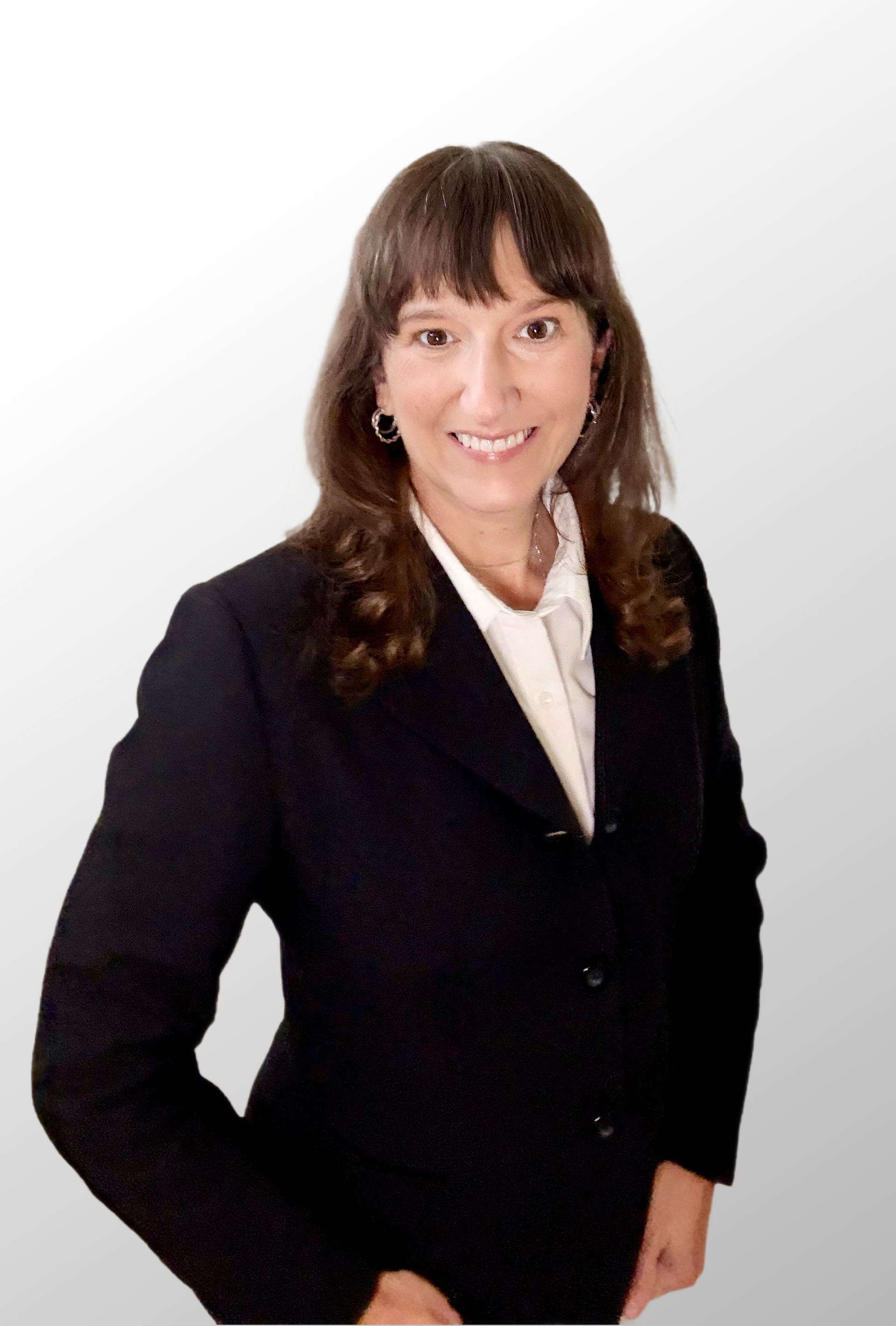 Woman in a black suit, smiling, against a white and gray gradient background.