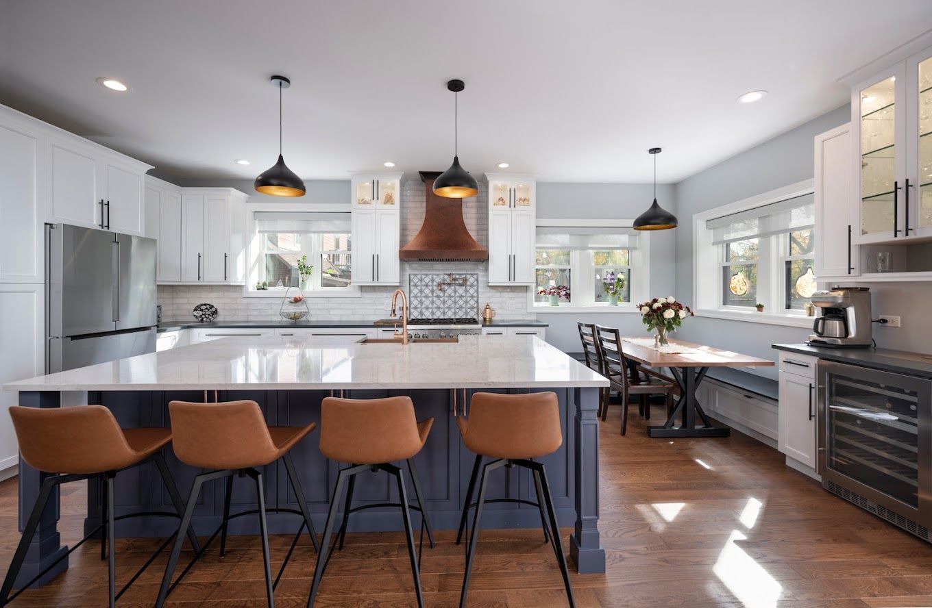 A kitchen with a large island and stools