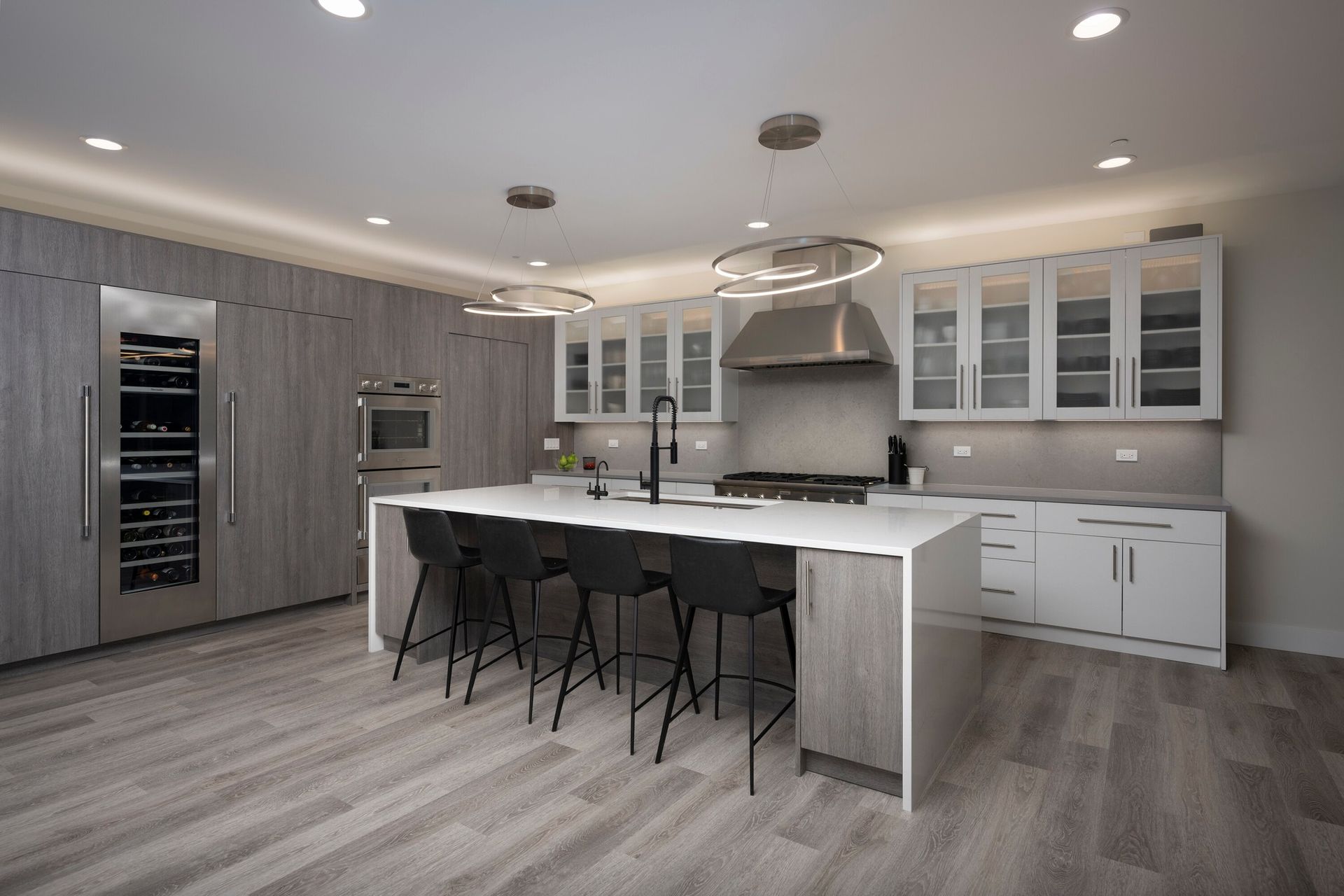 An artist 's impression of a kitchen with a large island and stools.