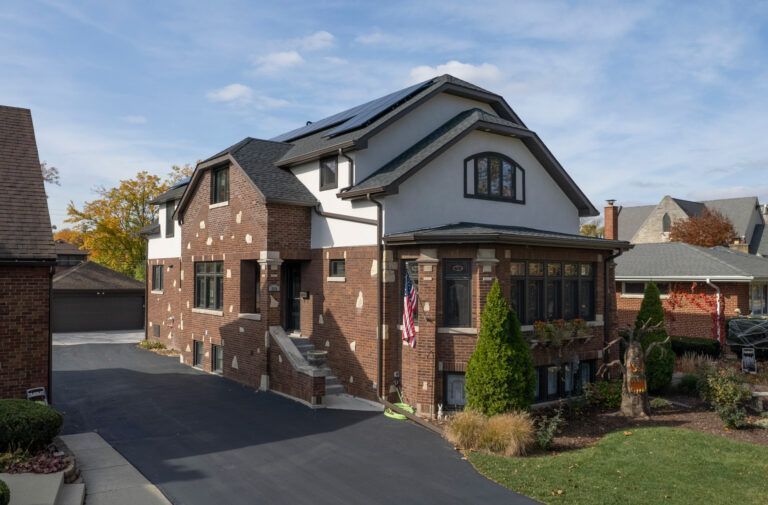 A large brick house with solar panels on the roof