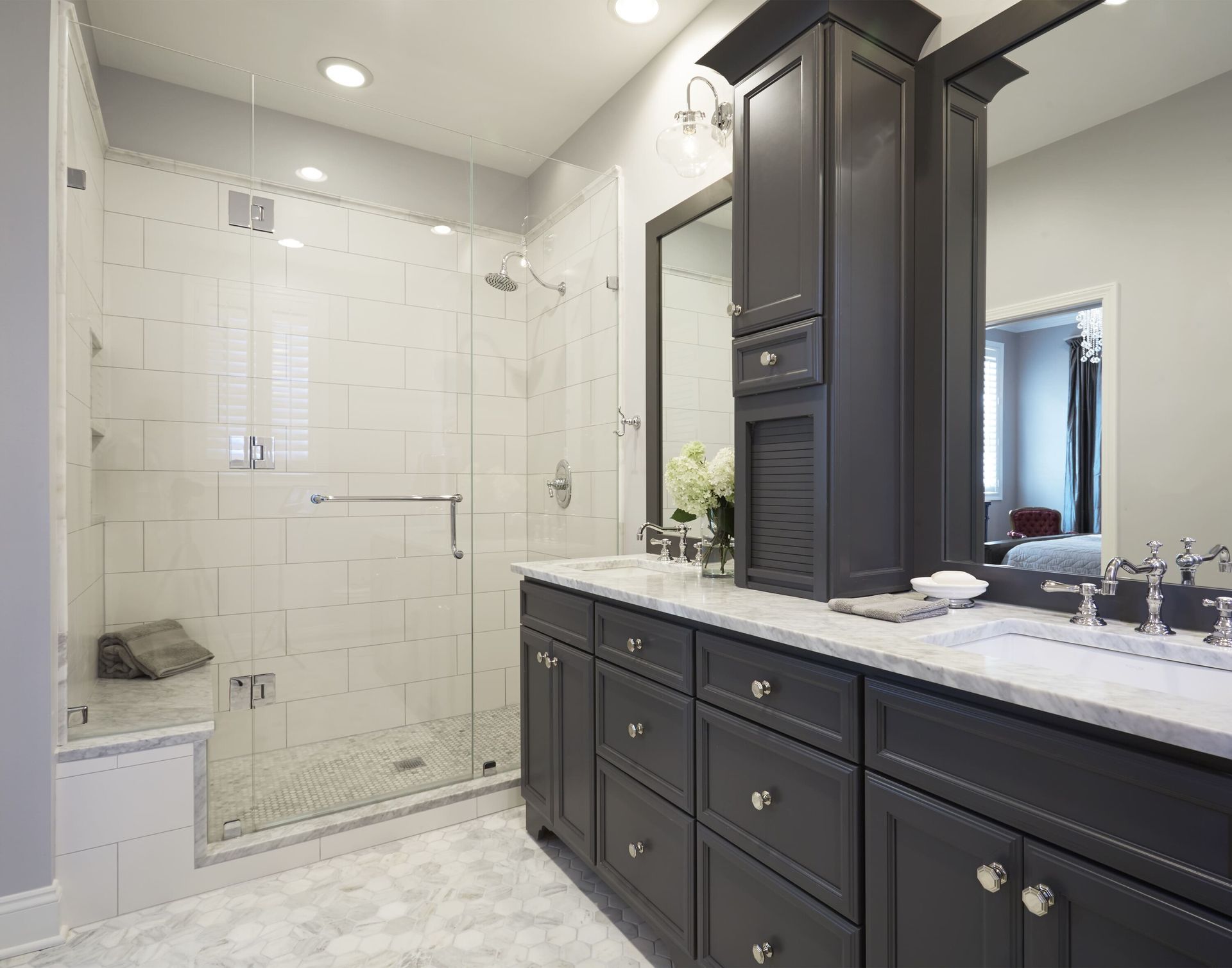 A bathroom with two sinks and a walk in shower.