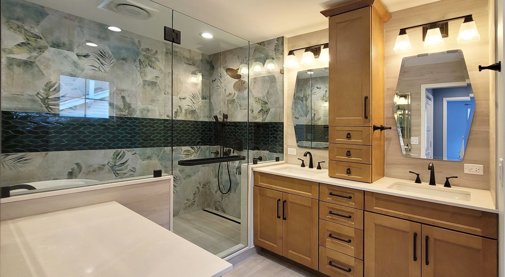 A bathroom with two sinks and a walk in shower.
