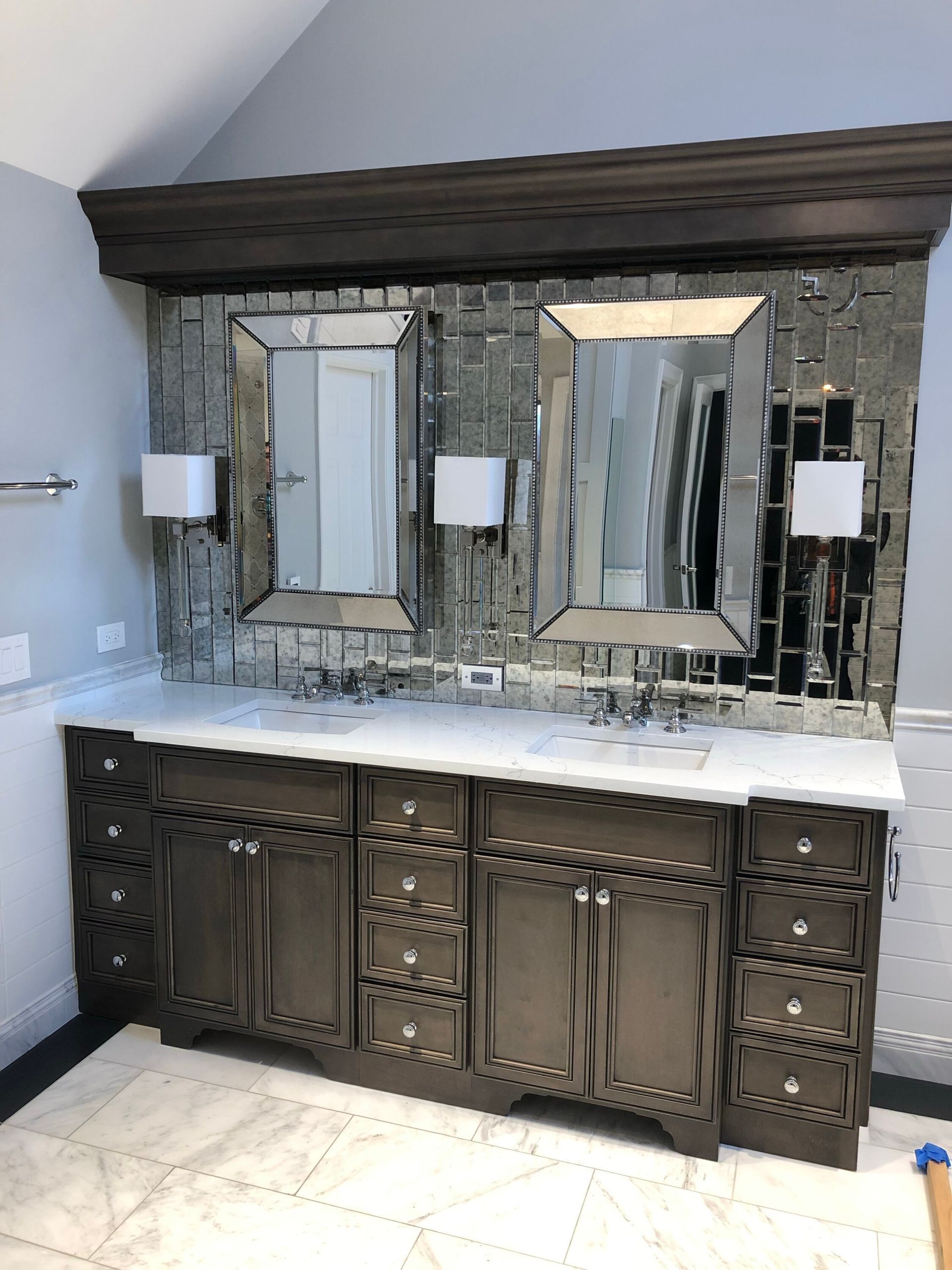 A bathroom with two sinks and two mirrors on the wall.