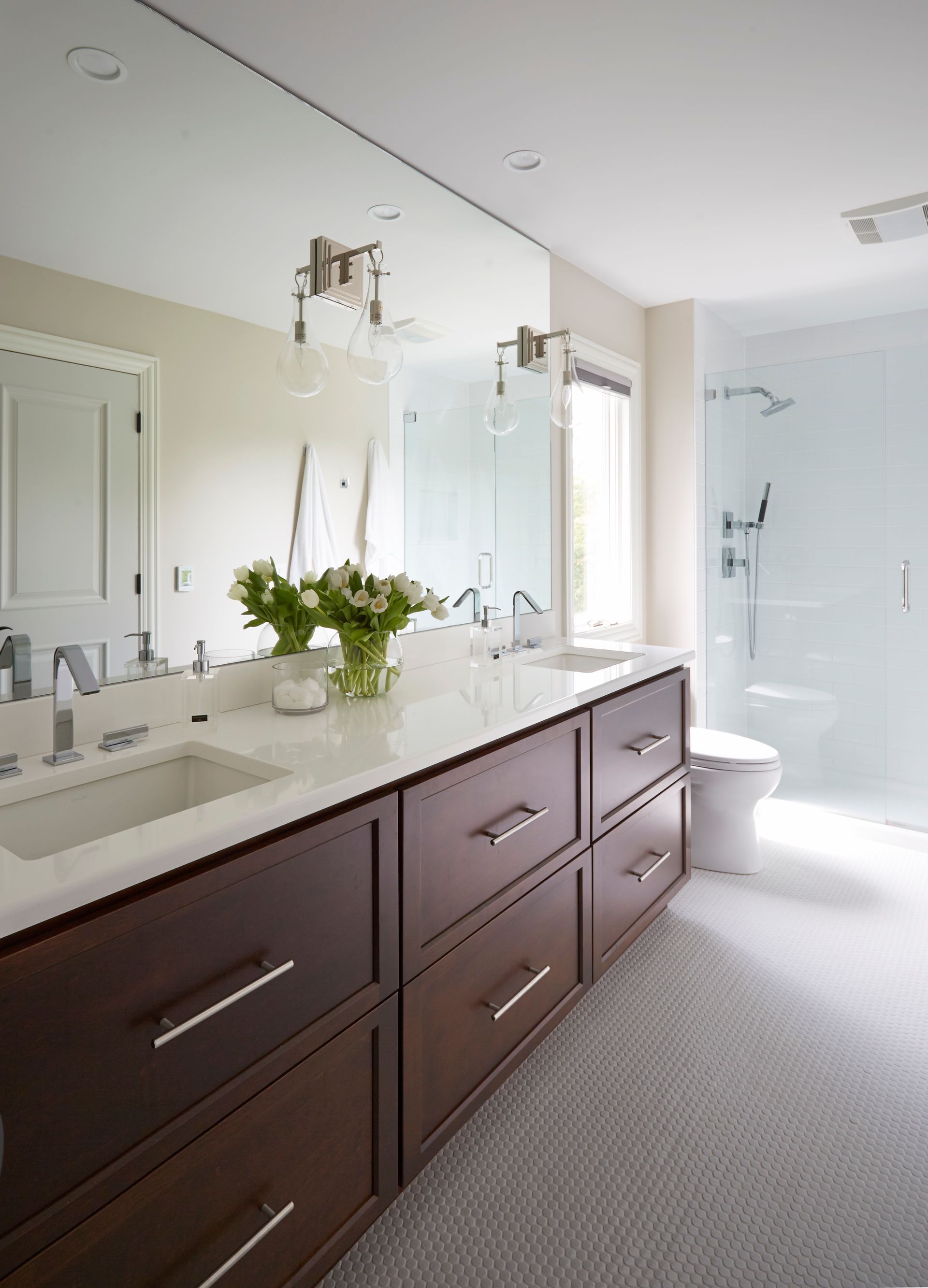 A bathroom with two sinks and a large mirror