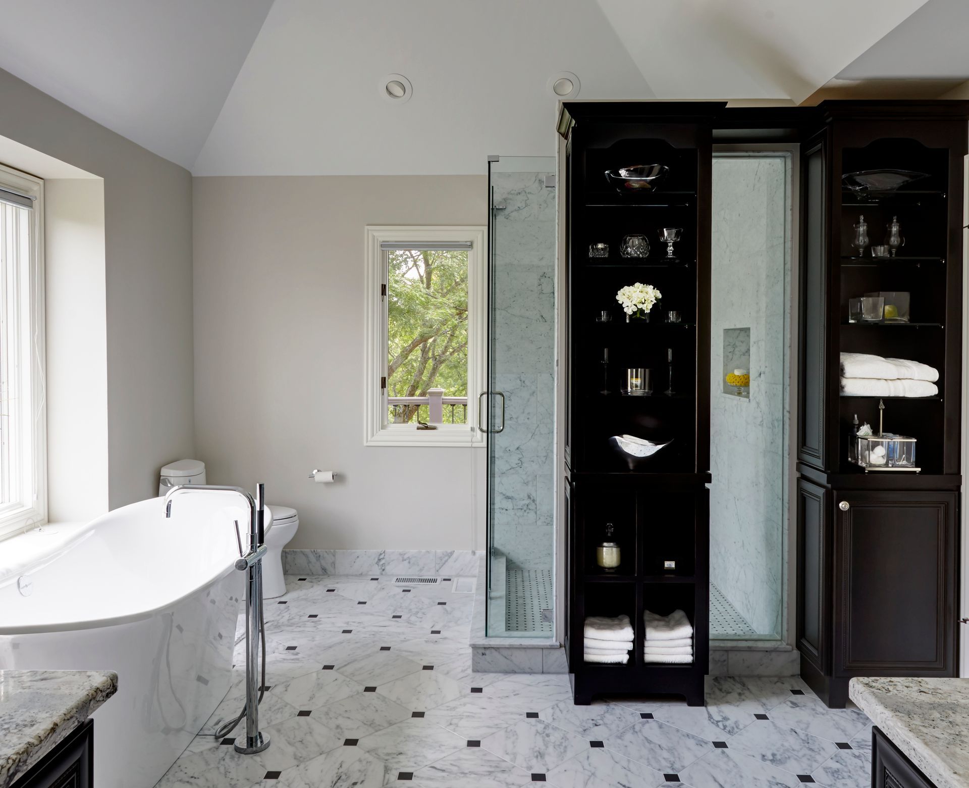 A bathroom with a tub a toilet and a shower