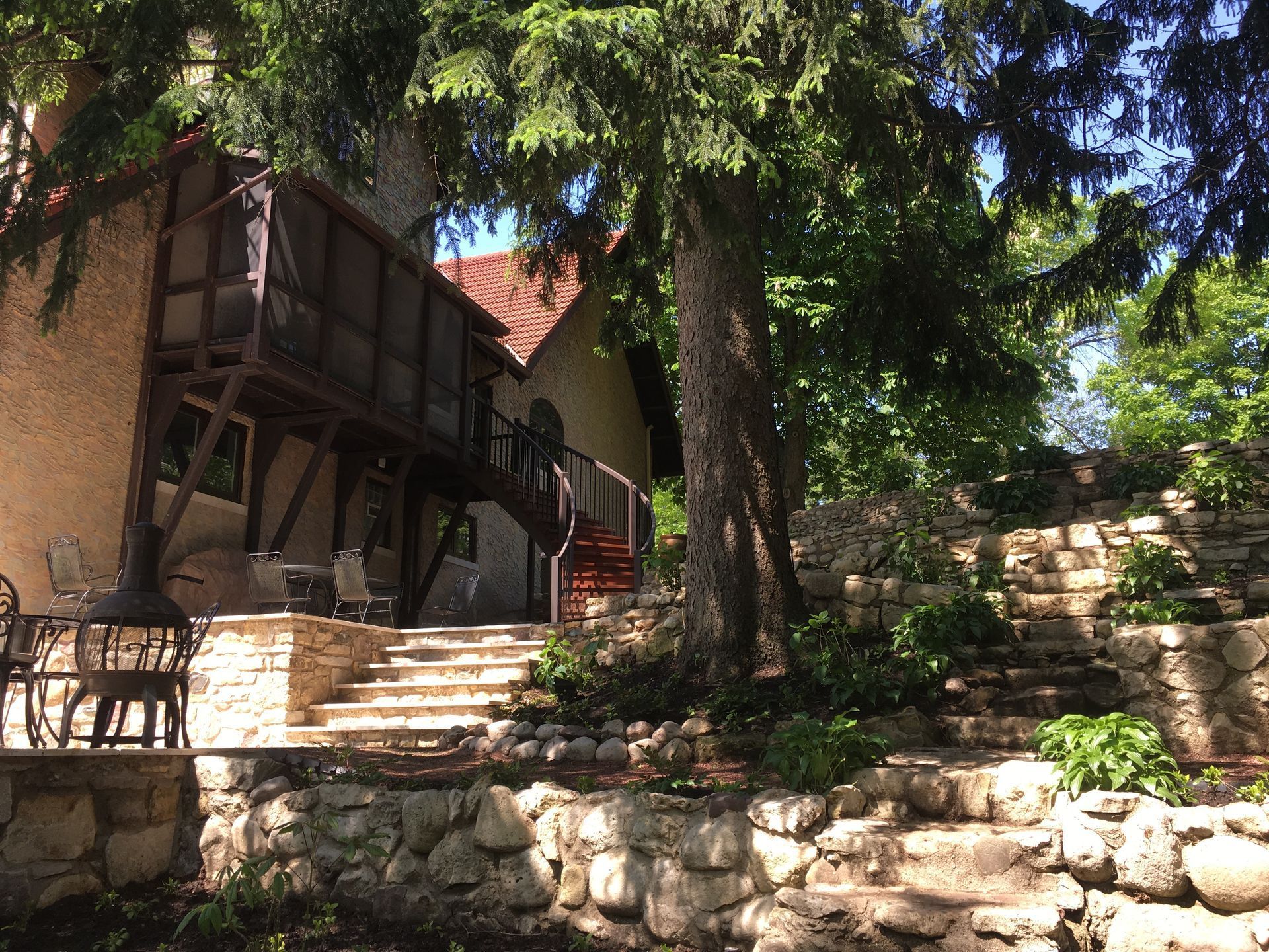 A house with stairs leading up to it surrounded by trees