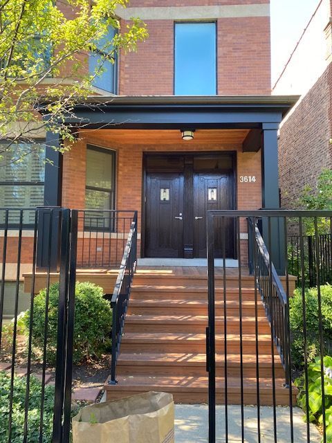A brick building with the number 3116 on the front door