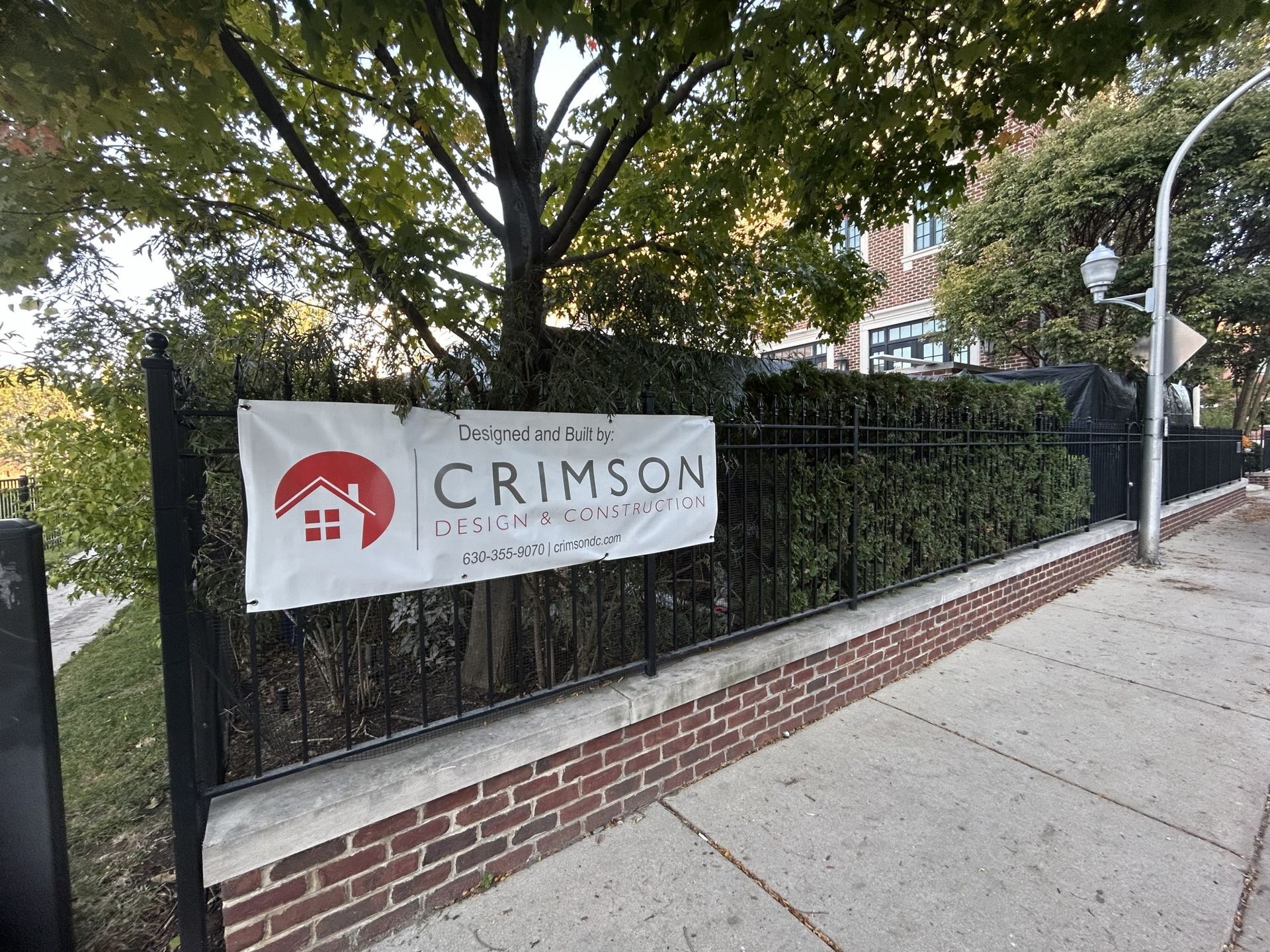 A sign on a fence that says crimson on it