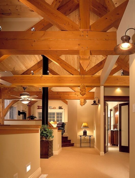 A hallway with wooden beams and a ceiling fan