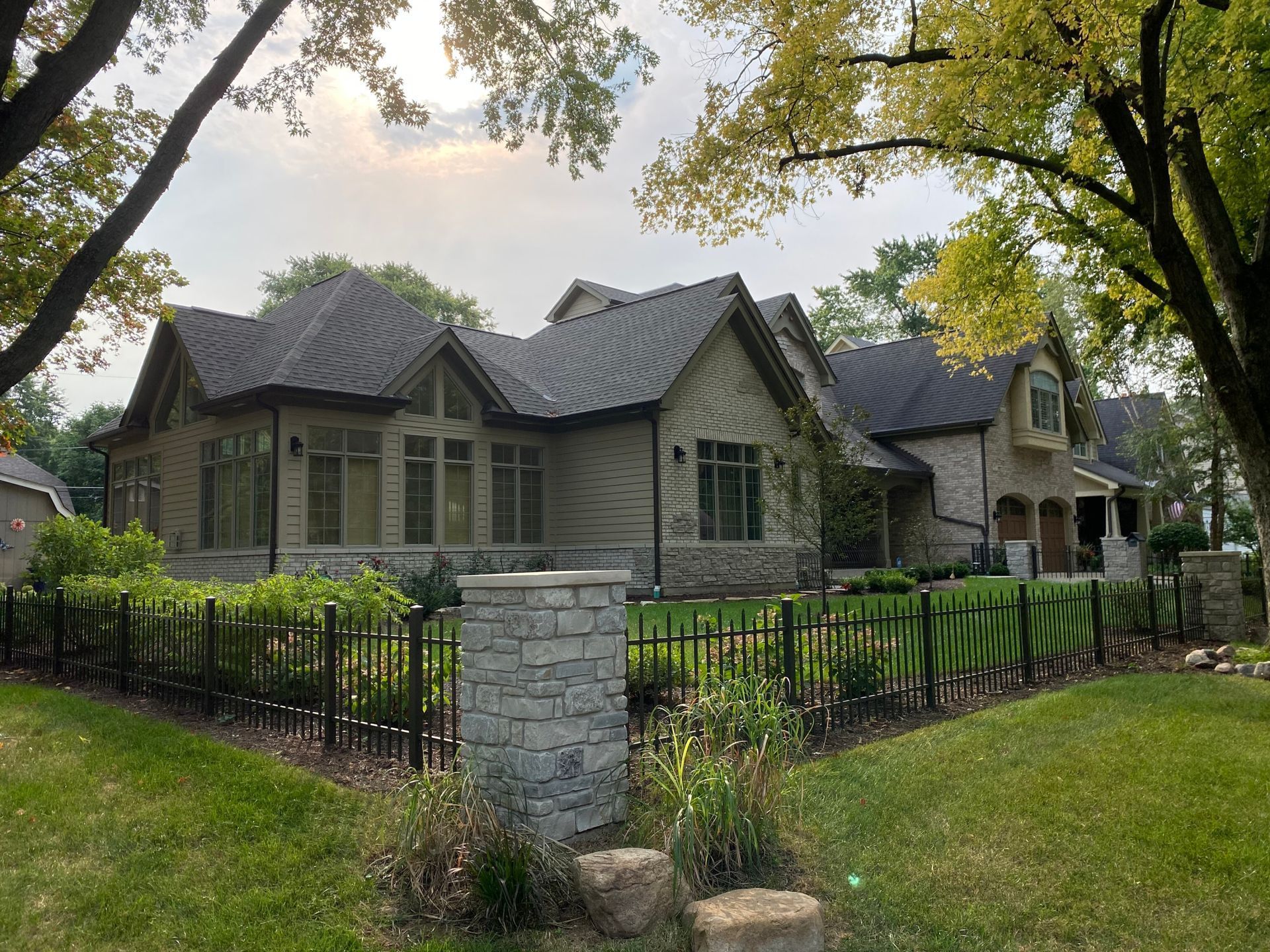 A large house with a fence in front of it