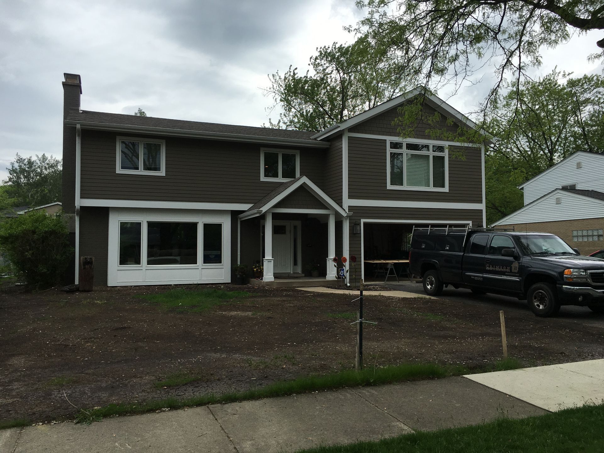 A large house with a truck parked in front of it