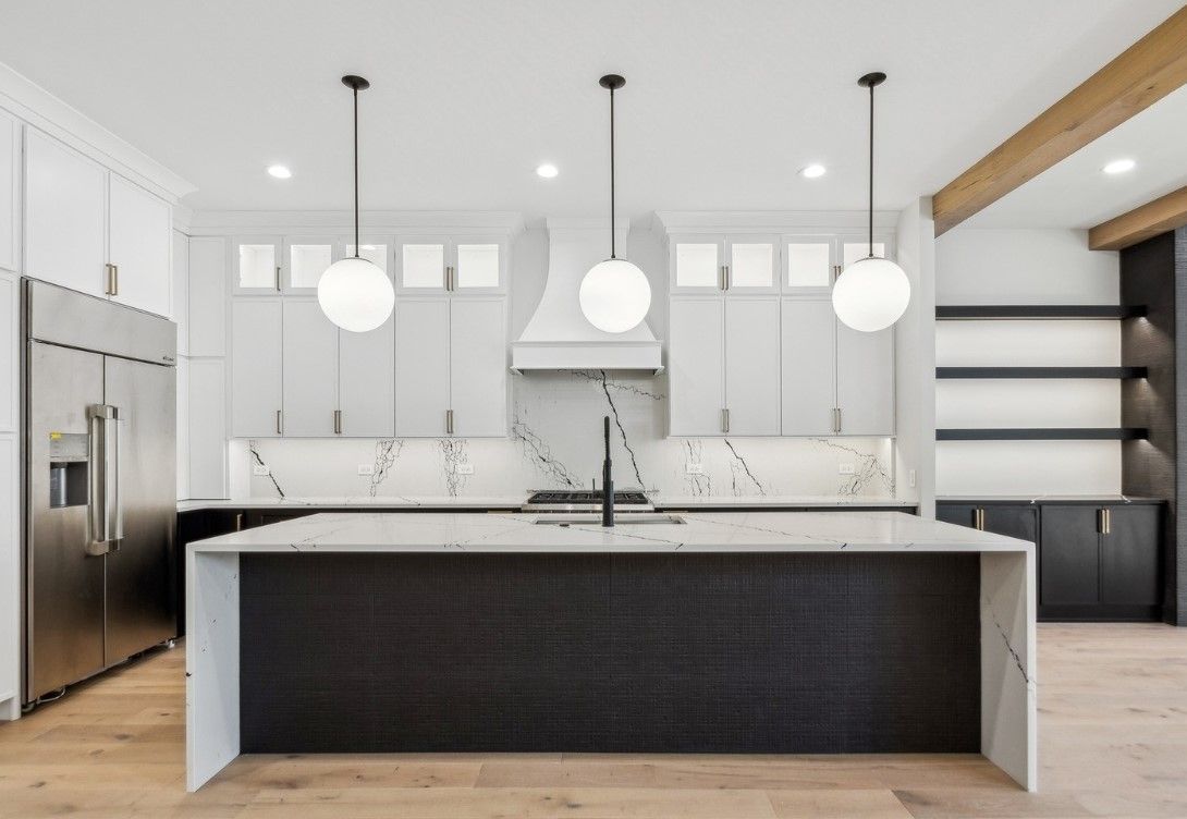 A kitchen with stainless steel appliances and a large island