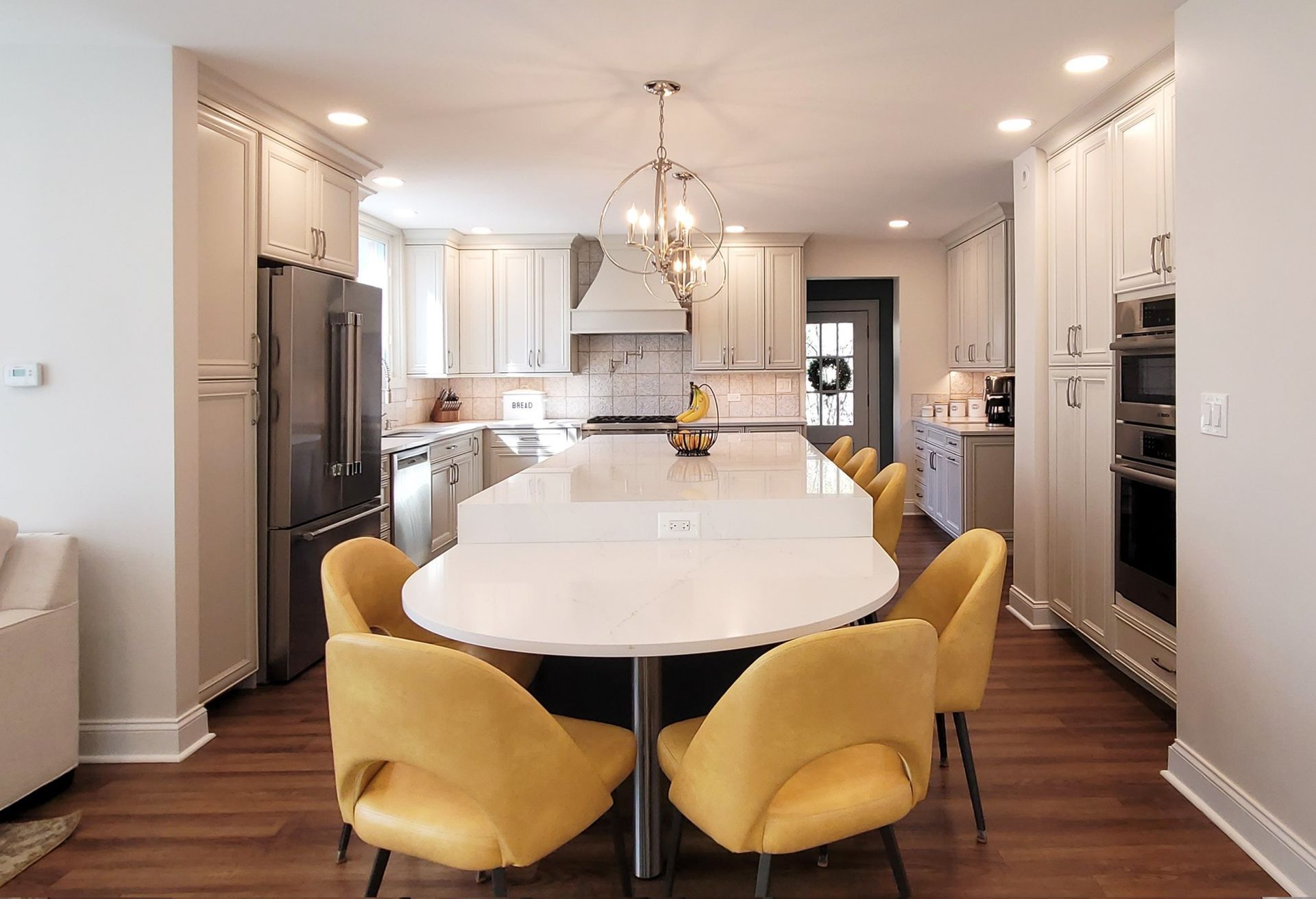 A kitchen with gray cabinets and stainless steel appliances