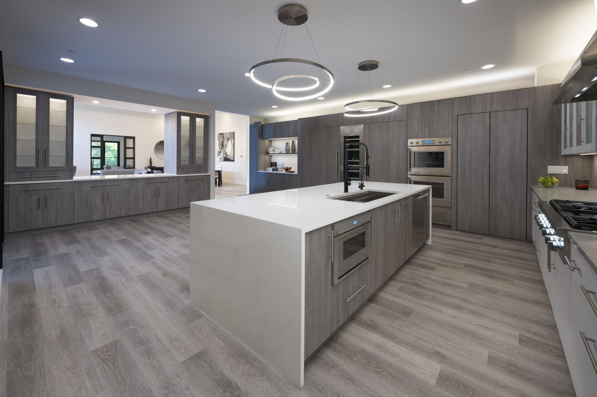 An artist 's impression of a kitchen with a large island in the middle.