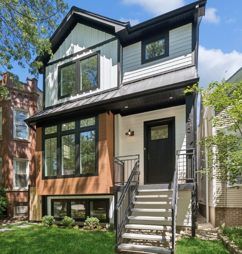 A house with stairs leading up to the front door