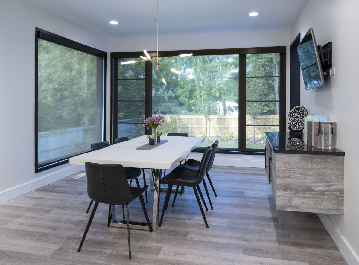 A dining room with a long table and chairs