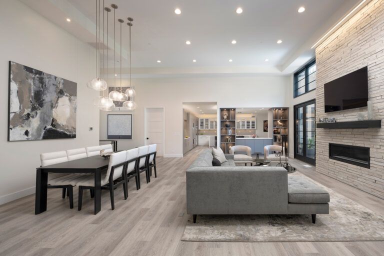 A living room with a couch , table , chairs and television.