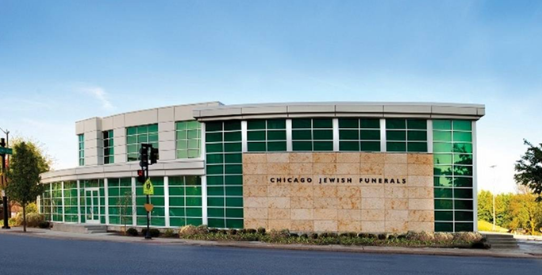 A large building with a lot of windows and a sign that says chicago jewish funerals.
