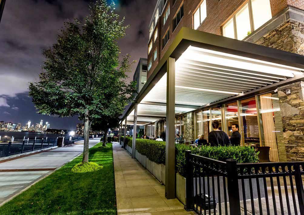 A sidewalk leading to a building with a canopy over it