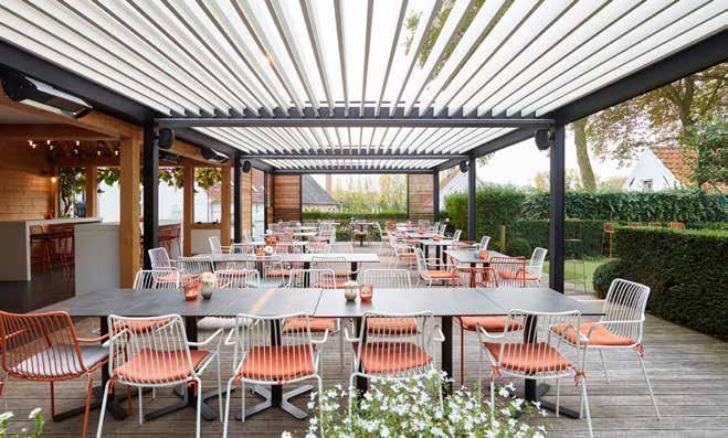 A restaurant with tables and chairs under a pergola.
