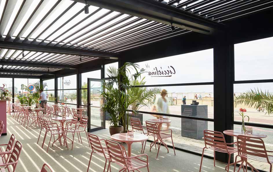 A restaurant with tables and chairs under a pergola.