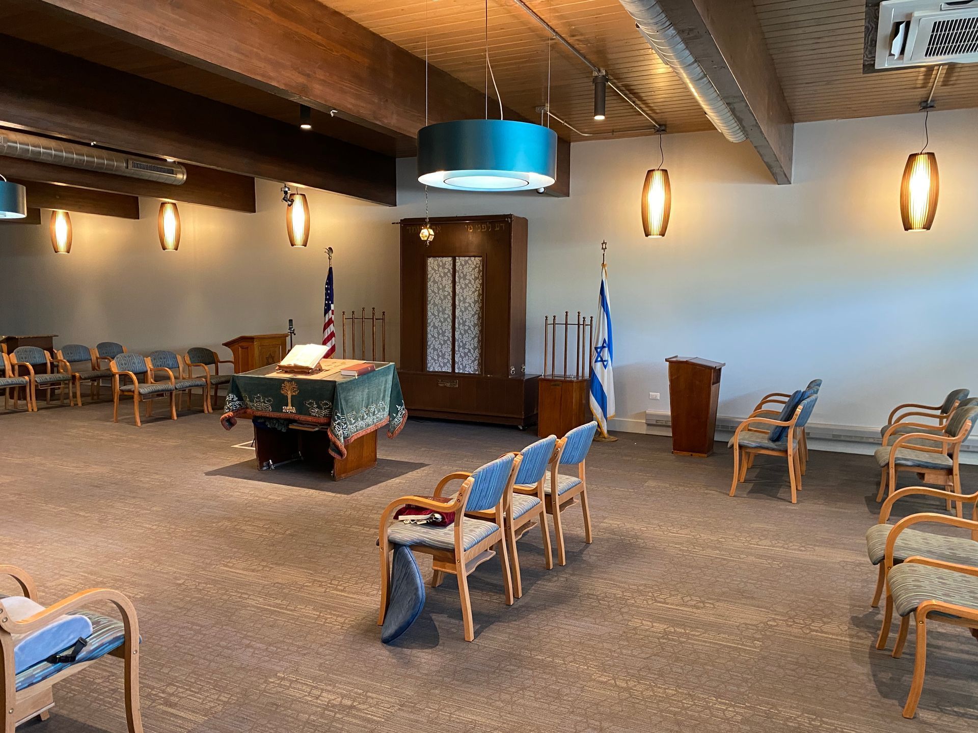 A large room with a table and chairs in it.