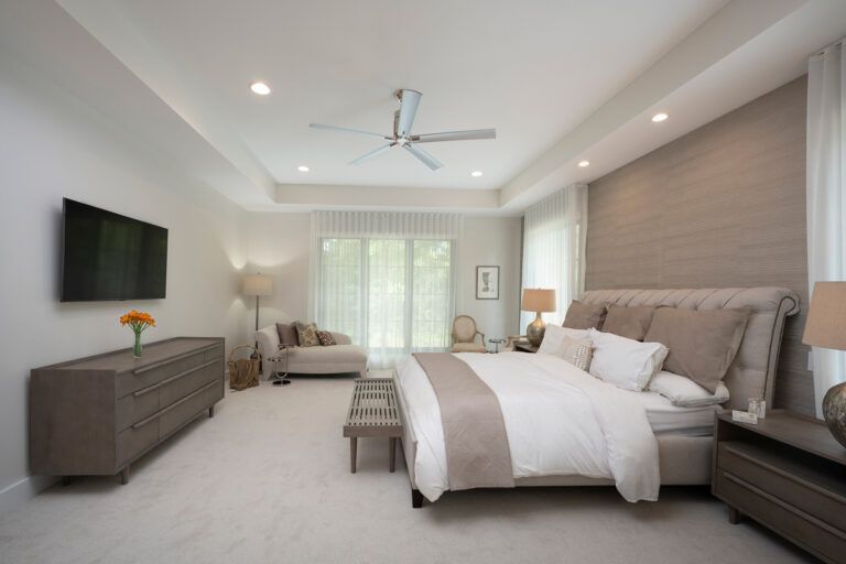 A bedroom with a large bed and a flat screen tv