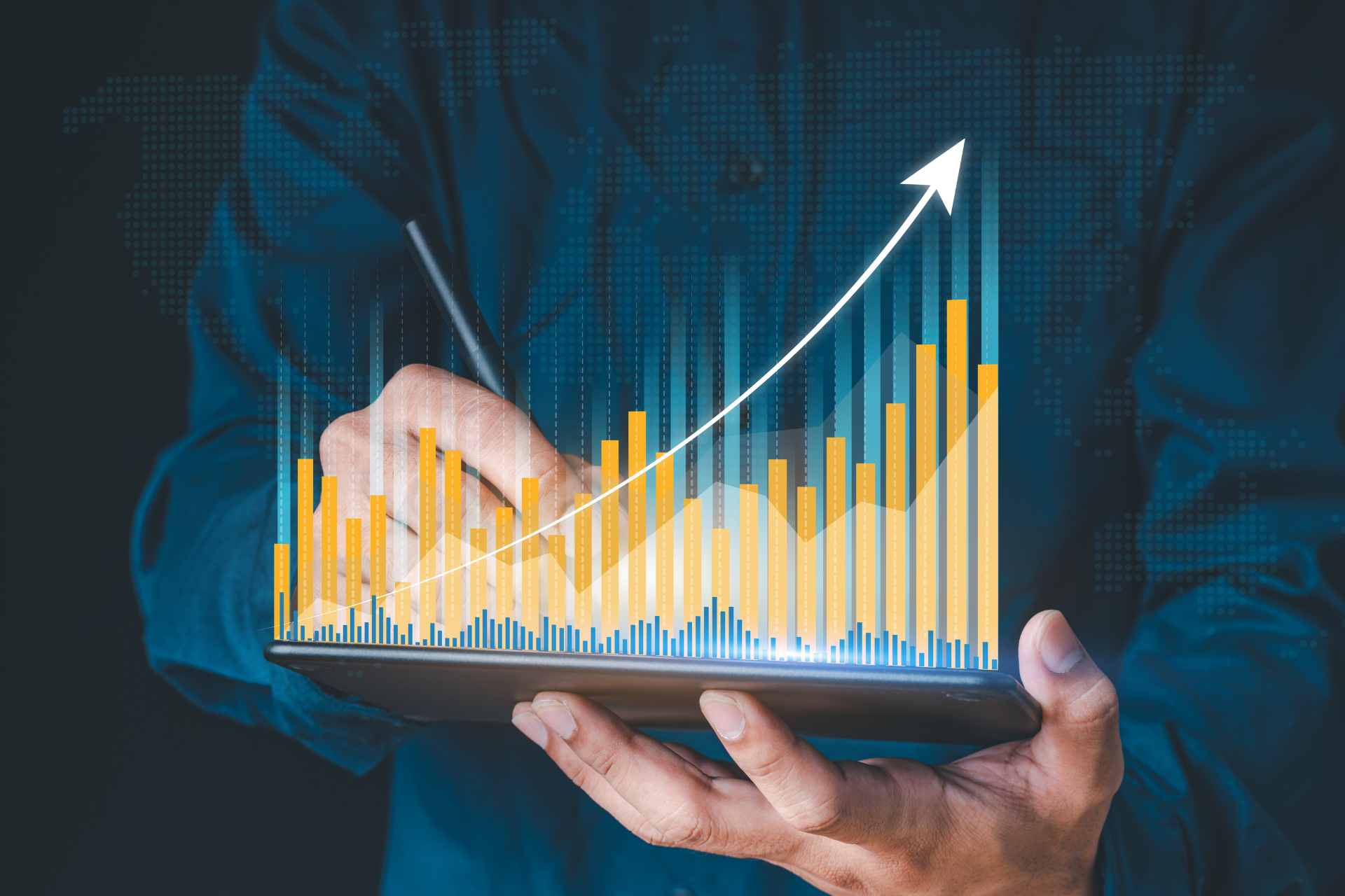 A man is holding a tablet with a graph on it.
