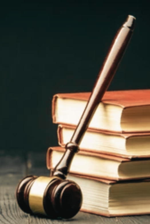 A man and a woman are carrying boxes up a set of stairs.