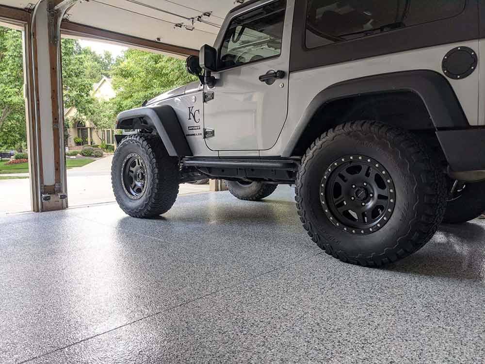 A jeep parked in a garage with a polyaspartic concrete floor coating