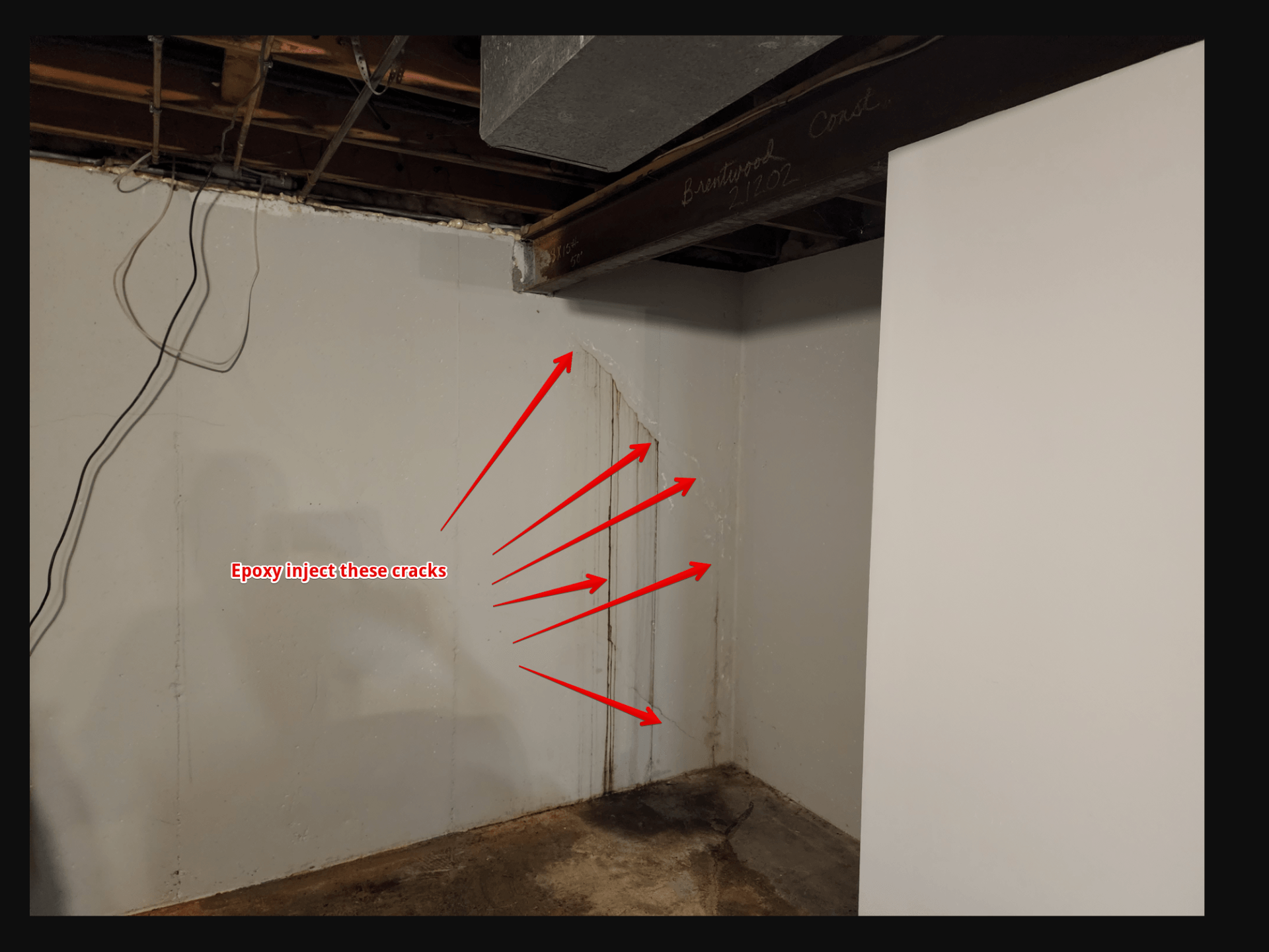 a large crack in a basement wall, with arrows pointing to areas where epoxy injections take place