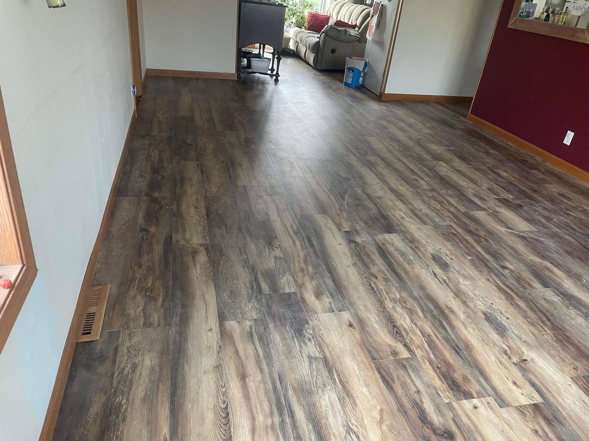 A living room with a wooden floor and a couch.