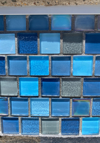 A wall with a lot of blue tiles on it