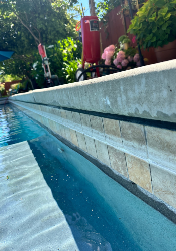 A close up of a wall with blue tiles on it.