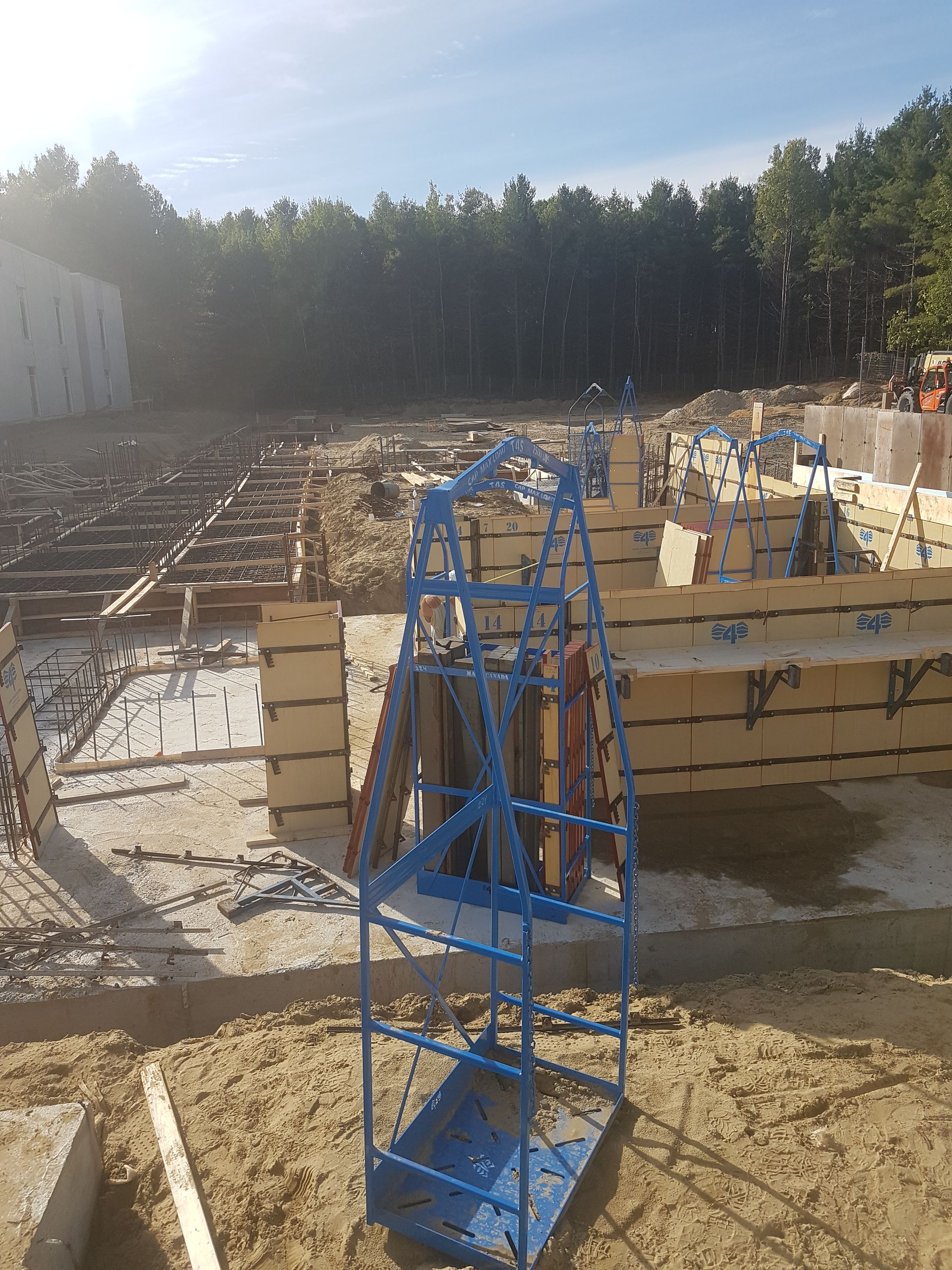 Une échelle bleue se trouve au milieu d'un chantier de construction.