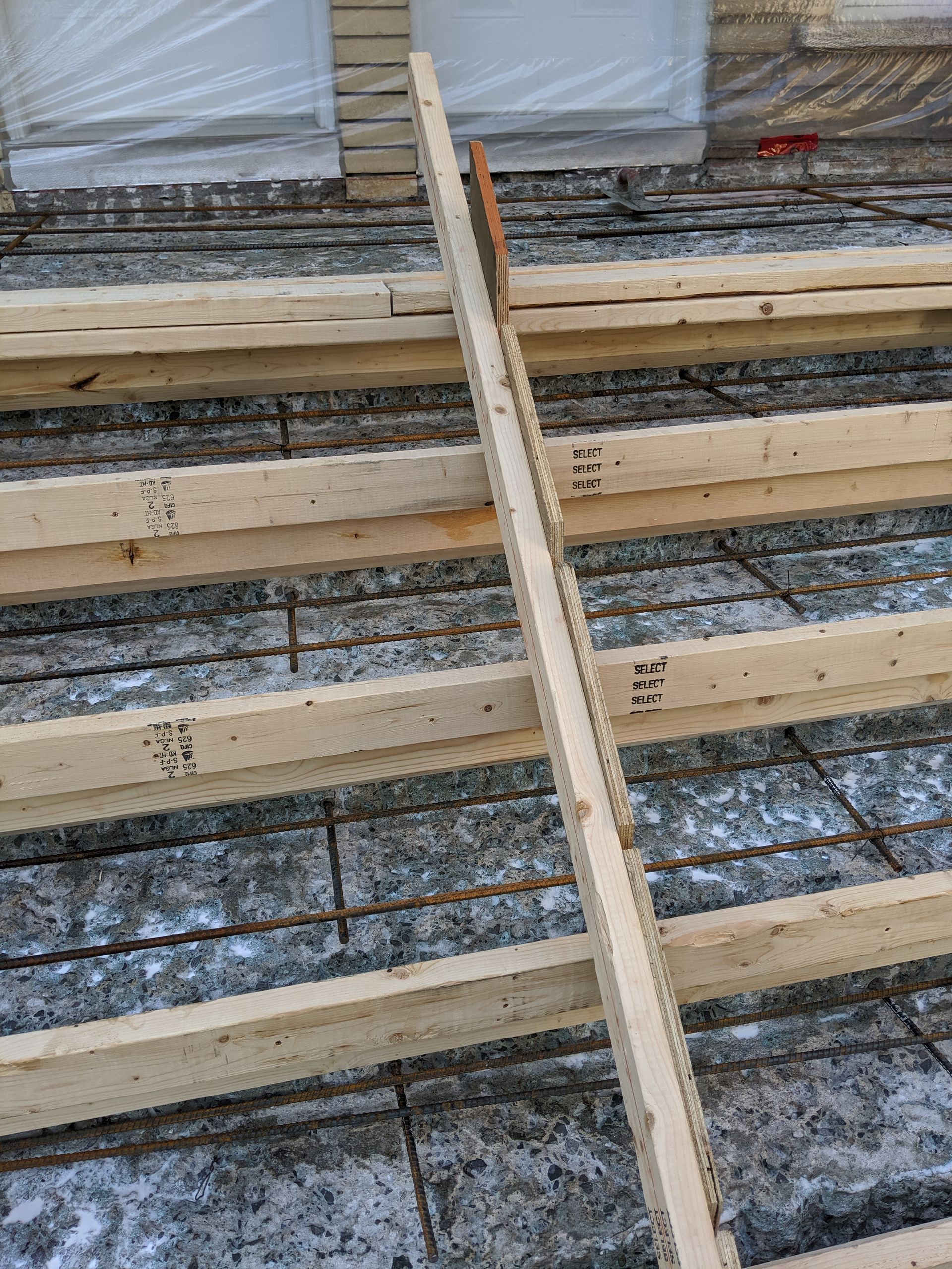 Une échelle en bois est posée sur un sol en béton.