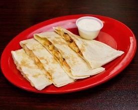 A red plate topped with quesadillas and a dipping sauce.