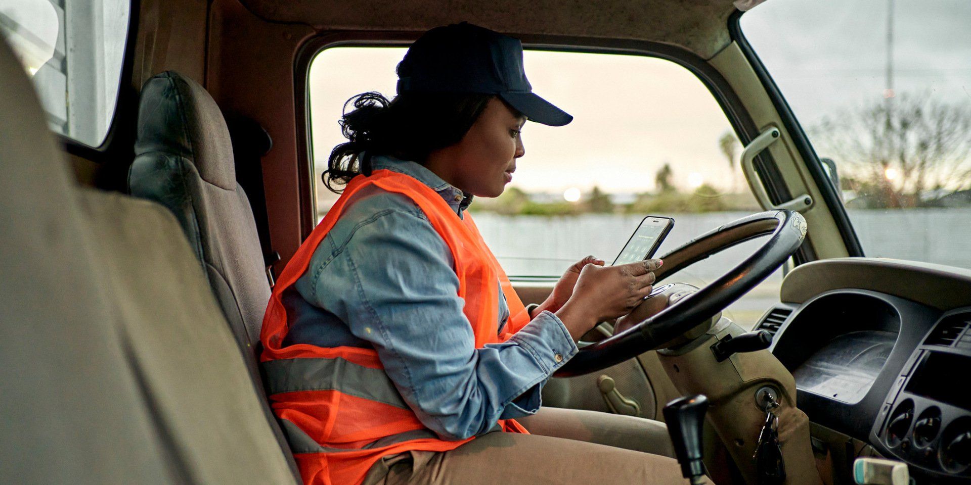 Truck Driver Checking Smart Phone - Arlington, TX - See The Fleet