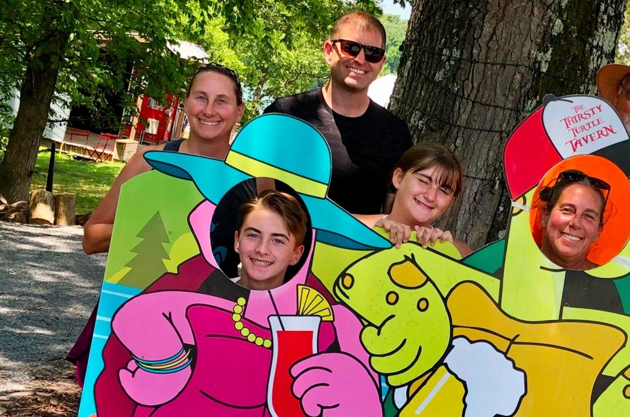 A group of people are posing for a picture with cartoon characters.