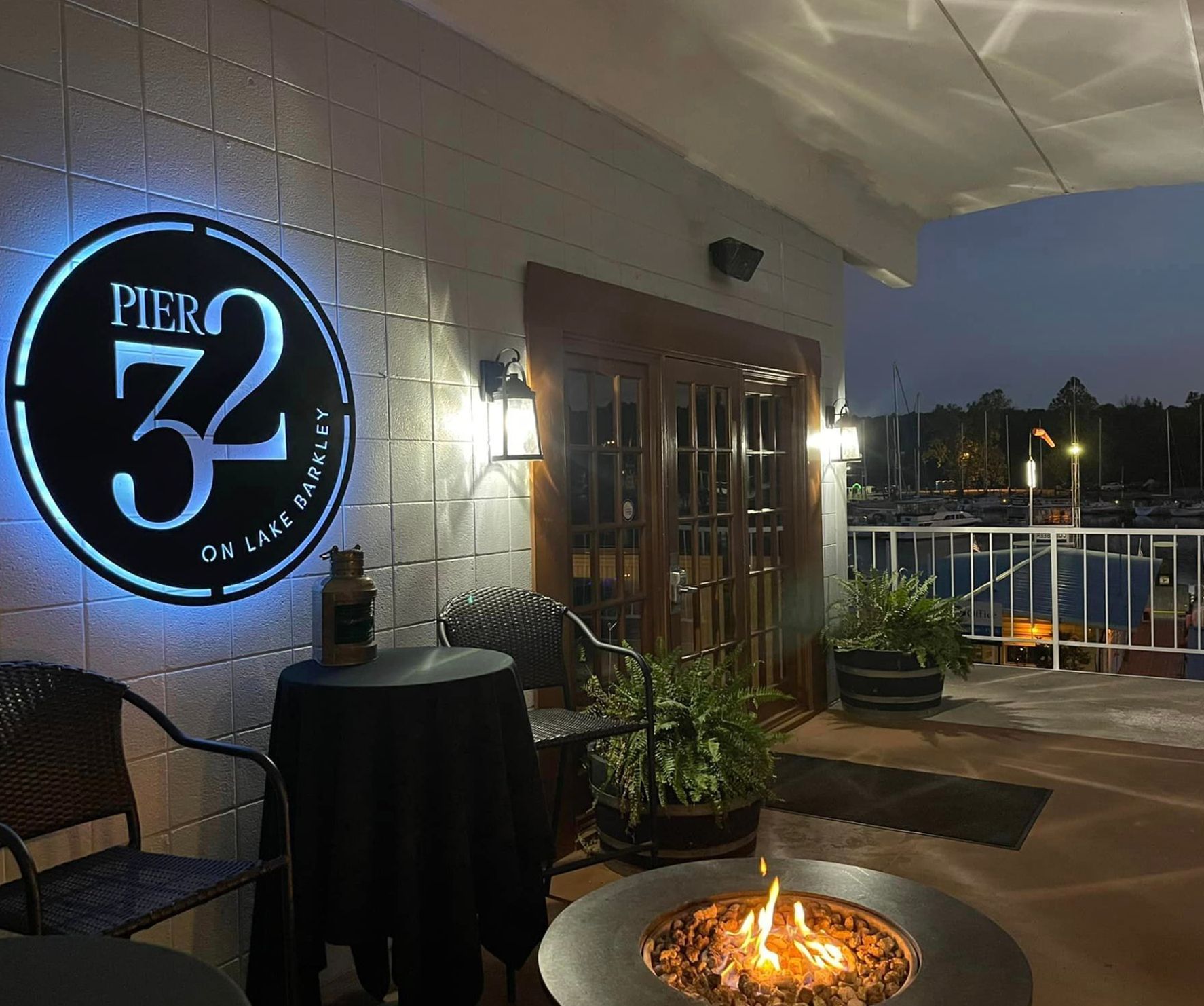 An aerial view of the Pier 32 restaurant building at Green Turtle Bay over the water.
