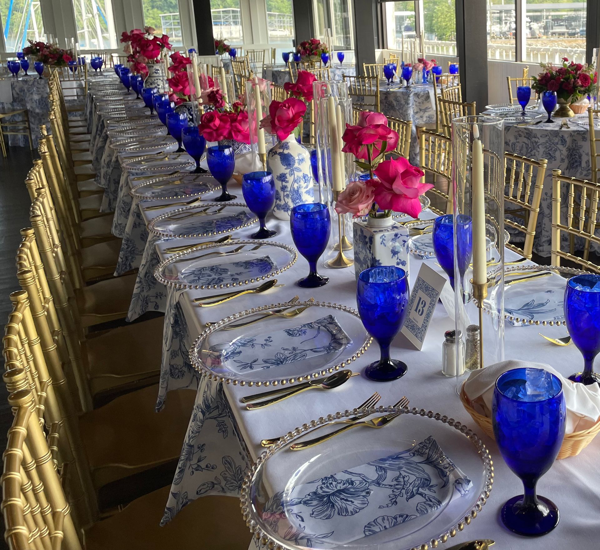A bride and groom are walking across a bridge . the bride is holding a bouquet of flowers.