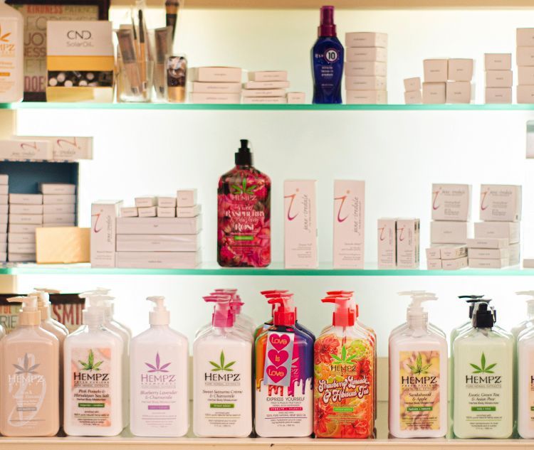 A shelf filled with bottles of hemp lotion