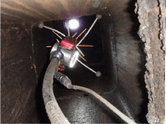 A hose with a light attached to it in a dark room