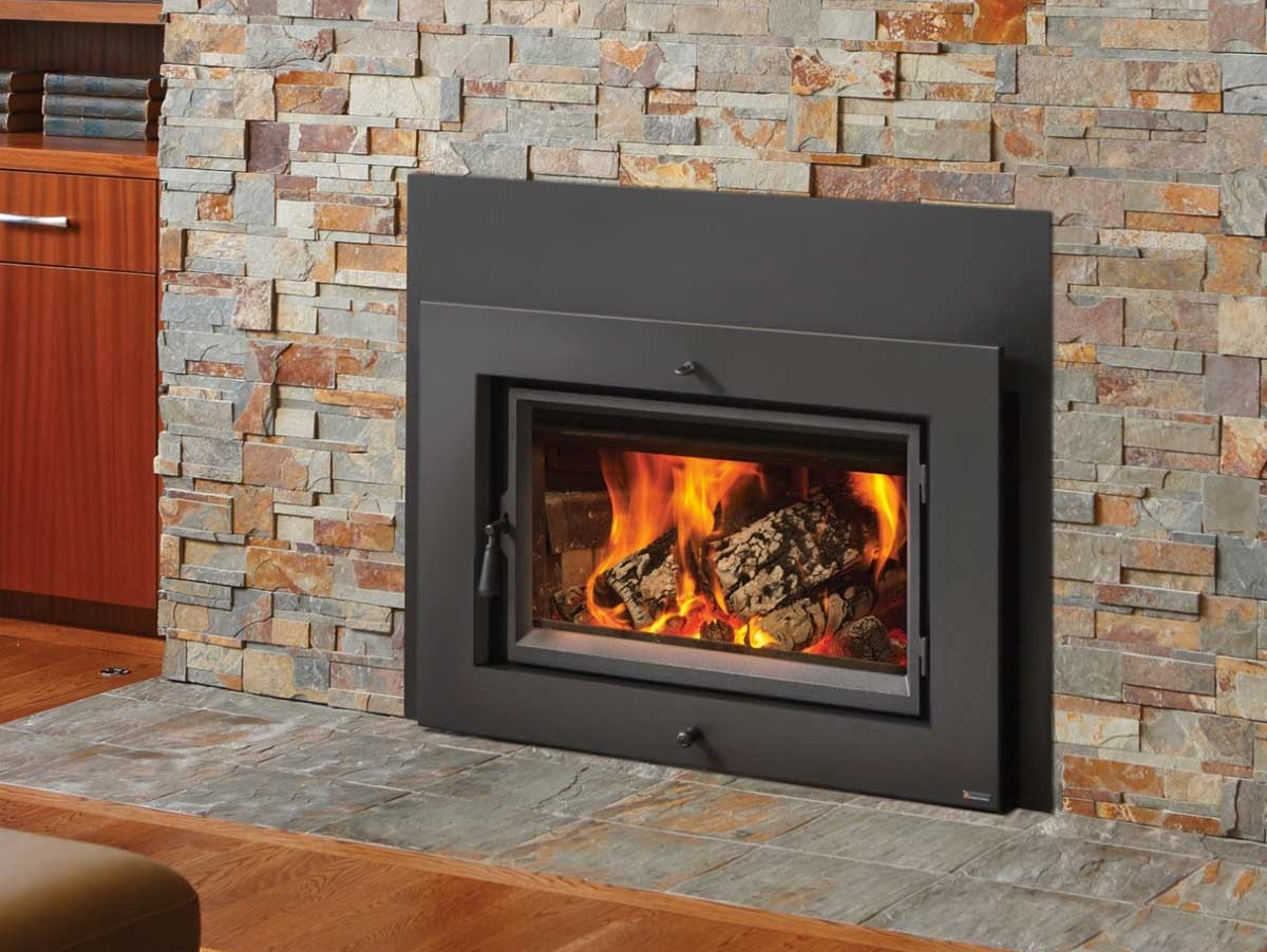 A fireplace is built into a stone wall in a living room.